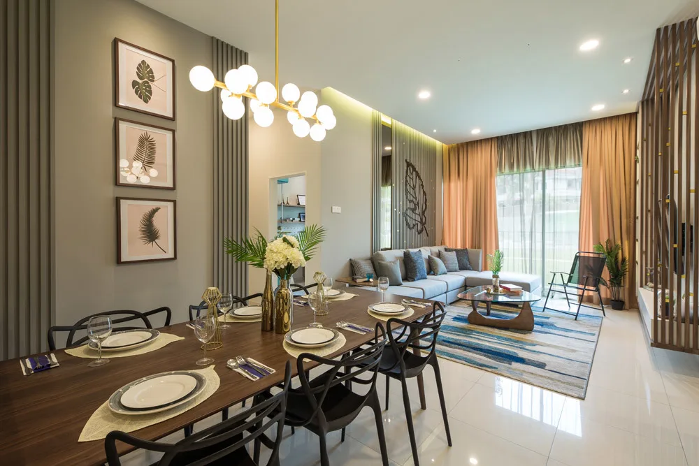 Alstonia Hilltop Homes @ Bukit Rahman Putra The image shows the interior of a unit, specifically the dining and living room area. The dining table is set with plates and glasses, and the living room features a sofa, coffee table, and curtains. in Shah Alam, Freehold property development, photo