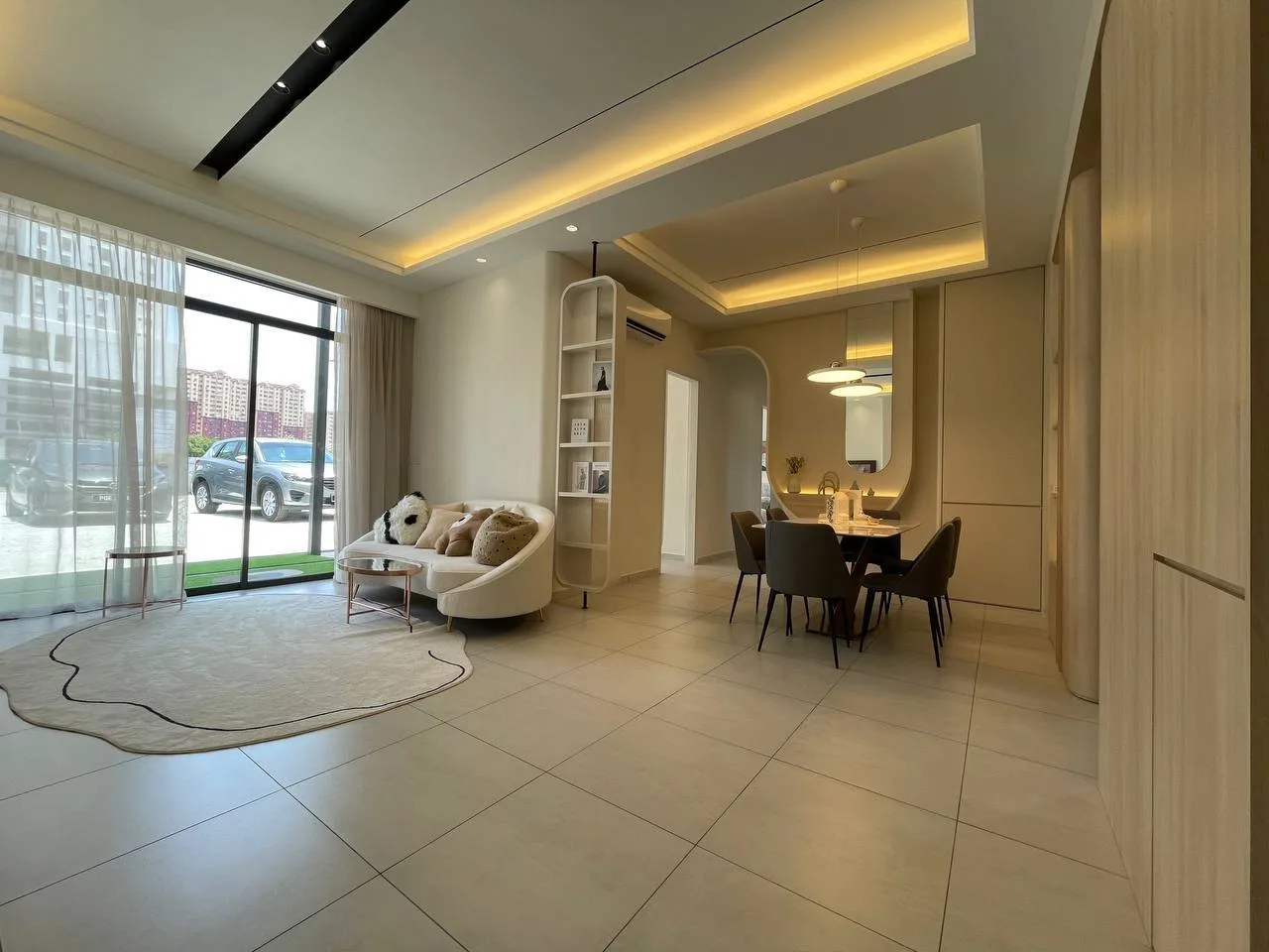 Alton Skyvillas Image shows the interior of a unit, featuring a living room with a sofa, a dining area with a table and chairs, and large windows. in Jelutong, Freehold property development, photo
