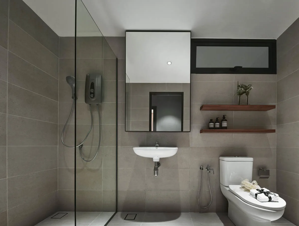 Anggun Residences, Design Village Image shows a bathroom with a shower, toilet, sink, mirror, and shelves. in Simpang Ampat, Leasehold property development, photo