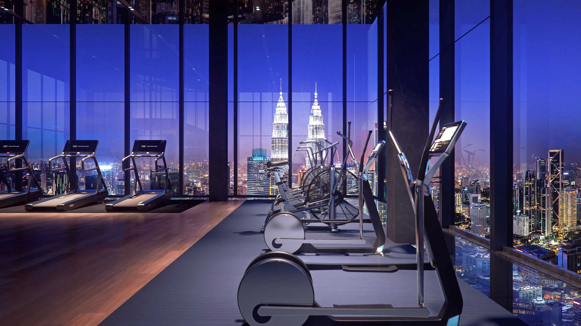 Core Residence at TRX The image shows the gym with treadmills and other exercise equipment with a view of the city skyline at night., Freehold property development, render