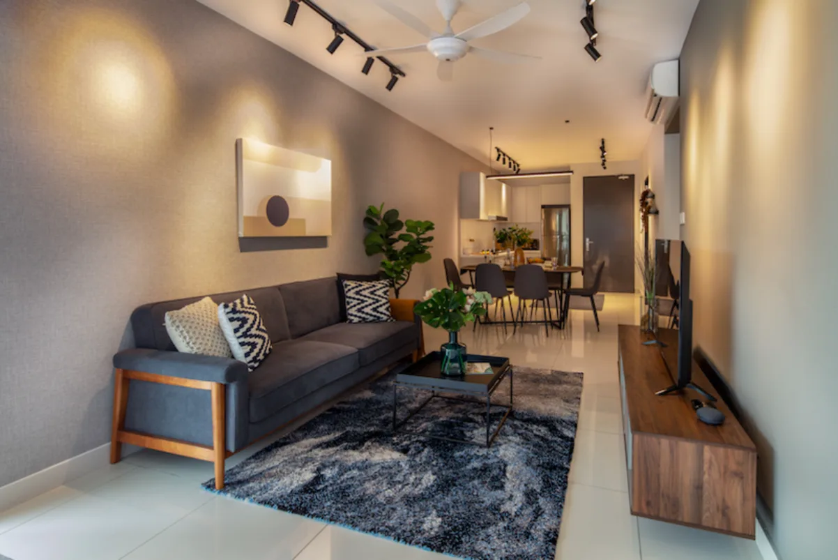 Gamuda Gardens Living room and dining area of a unit, showing a sofa, coffee table, TV console, dining table and chairs. in Rawang, Leasehold property development, photo